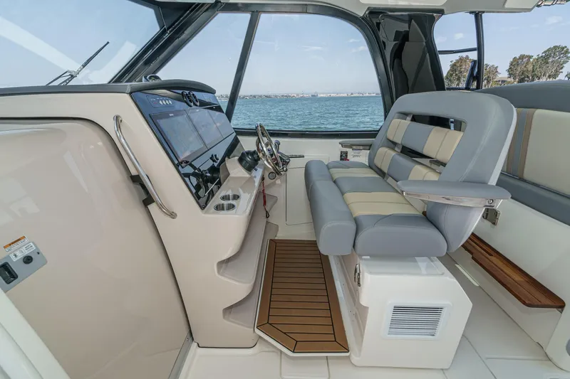 Slide: The Image of 2024 Boston Whaler 380 Realm helm with modern controls and comfortable seating. - 60