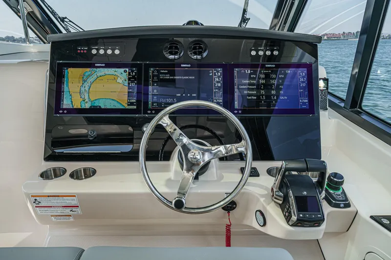 Slide: The Image of 2024 Boston Whaler 380 Realm helm with advanced navigation displays and controls. - 61