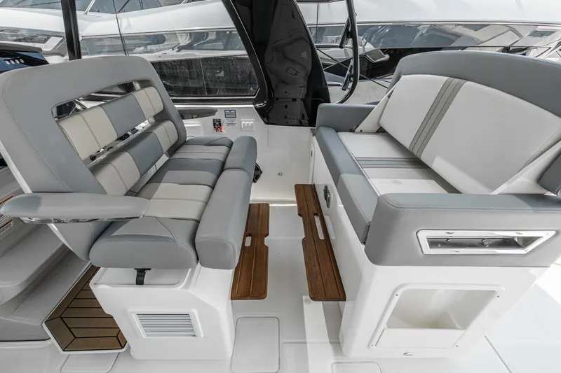 Slide: The Image of 2024 Boston Whaler 380 Realm interior seating with gray and white upholstery. - 65