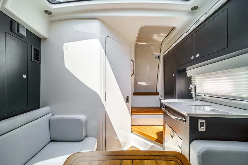 Slide: The Image of 2024 Boston Whaler 380 Realm interior with modern kitchen and seating area. - 71
