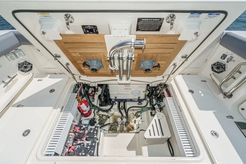 Slide: The Image of 2024 Boston Whaler 380 Realm engine compartment with equipment and wiring details. - 78
