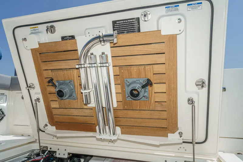 Slide: The Image of 2024 Boston Whaler 380 Realm boat hatch with wooden paneling and metal fixtures. - 79