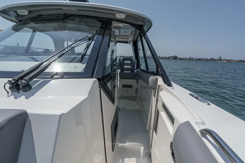 Slide: The Image of 2024 Boston Whaler 380 Realm boat interior with sleek design and waterfront view. - 83