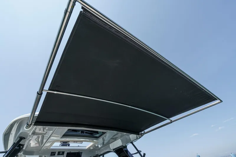 Slide: The Image of Boston Whaler 380 Realm 2024 boat canopy against clear blue sky. - 84