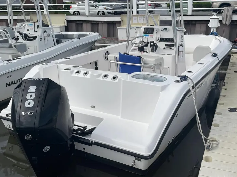 Slide: The Image of 2023 Aquasport 22CC boat with Mercury 200 V6 engine docked at marina. - 14