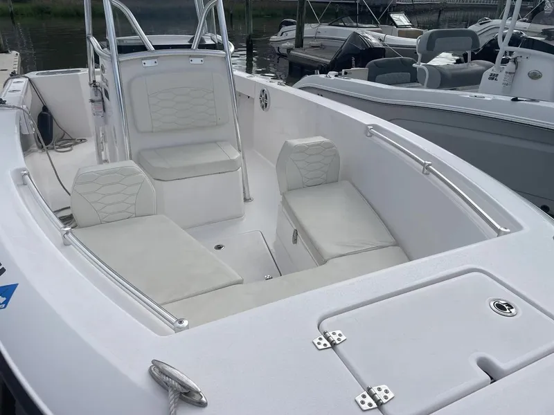 Slide: The Image of 2023 Aquasport 22CC boat interior with white seating and sleek design. - 17