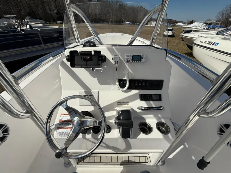 Slide: The Image of 2023 Aquasport 22CC boat console with steering wheel and navigation controls. - 8
