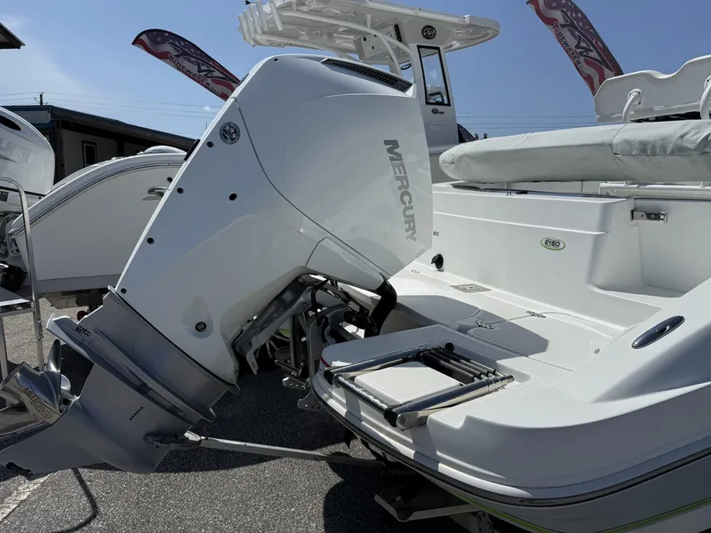 Slide: The Image of 2025 Tahoe 215 CC OB boat with Mercury outboard motor, displayed outdoors. - 3