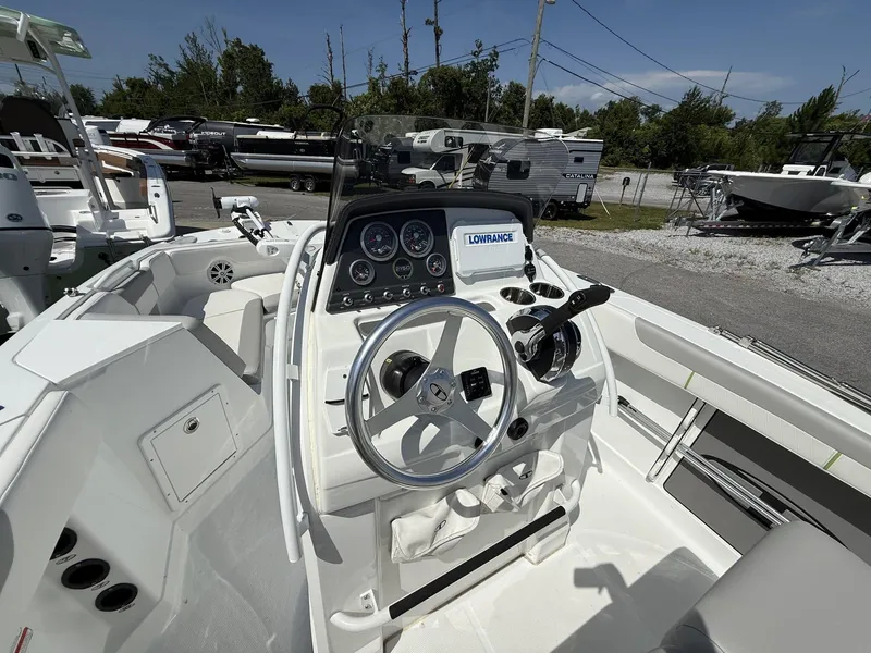 Slide: The Image of 2025 Tahoe 215 CC OB boat interior with steering wheel and control panel. - 8