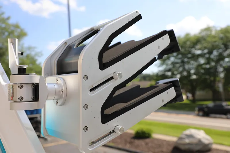 Slide: The Image of Close-up of a 2021 Centurion Ri245 boat's wakeboard rack in a sunny outdoor setting. - 14