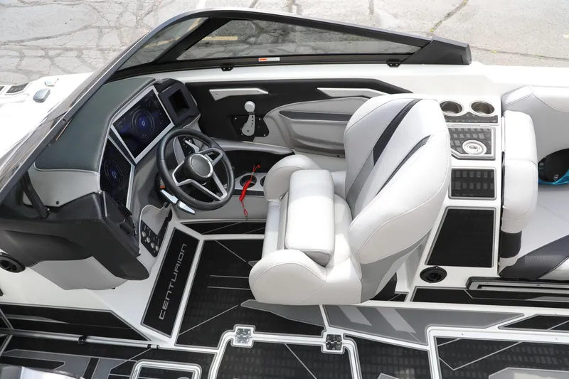 Slide: The Image of 2021 Centurion Ri245 boat interior with modern dashboard and steering wheel. - 2