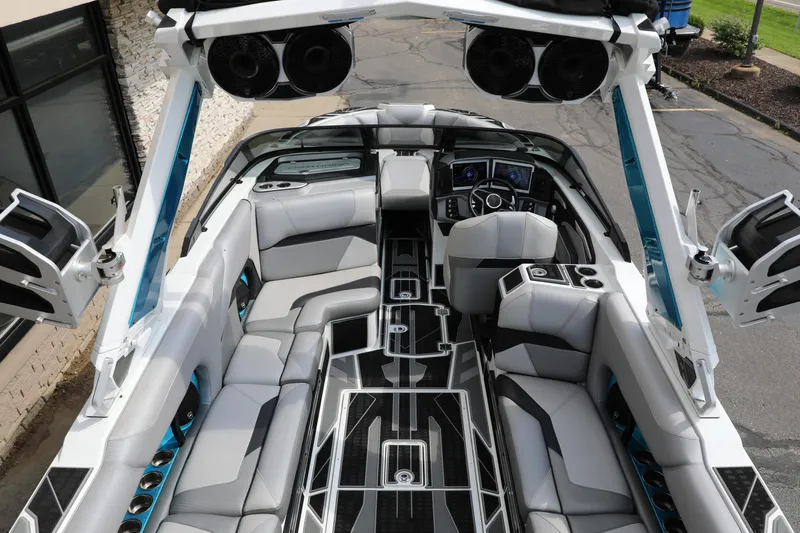 Slide: The Image of 2021 Centurion Ri245 boat interior with sleek seating and advanced dashboard features. - 9