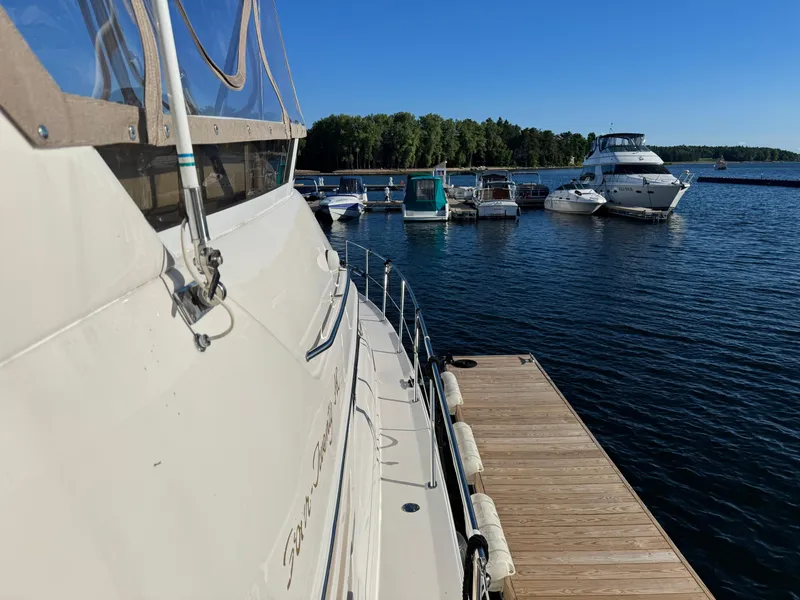 Slide: The Image of 1998 Sea Ray 420 Aft Cabin yacht docked at marina with clear blue sky. - 14