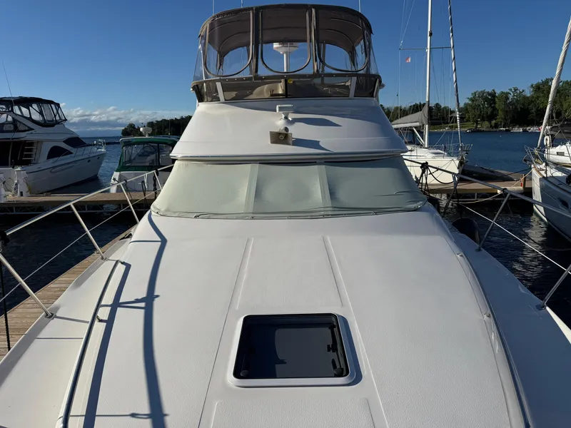 Slide: The Image of 1998 Sea Ray 420 Aft Cabin yacht docked at marina, sunny day. - 16