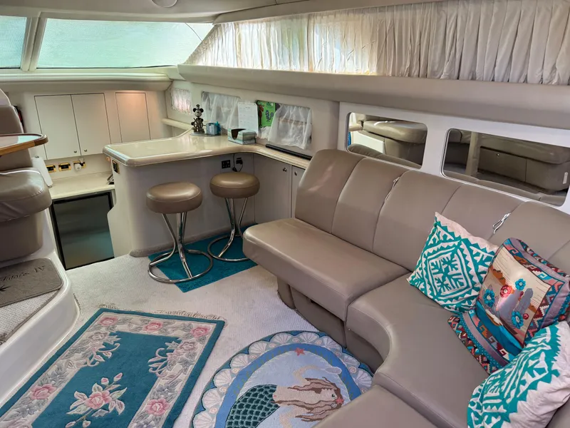 Slide: The Image of Luxurious interior of 1998 Sea Ray 420 Aft Cabin with plush seating and decorative pillows. - 18