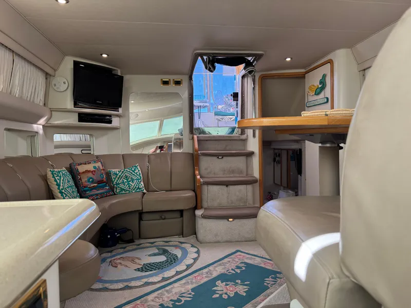Slide: The Image of Interior of 1998 Sea Ray 420 Aft Cabin yacht with cozy seating and nautical decor. - 26