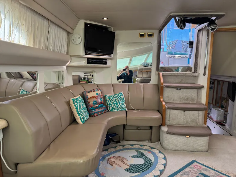 Slide: The Image of Interior of 1998 Sea Ray 420 Aft Cabin with cozy seating and nautical decor. - 27