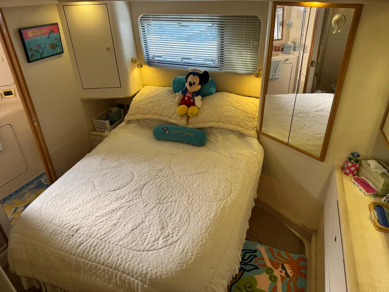 Slide: The Image of Cozy bedroom in 1998 Sea Ray 420 Aft Cabin with plush decor and nautical theme. - 29