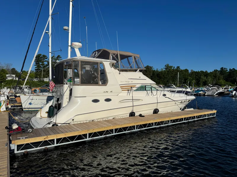 Slide: The Image of 1998 Sea Ray 420 Aft Cabin yacht docked at marina under clear blue sky. - 3