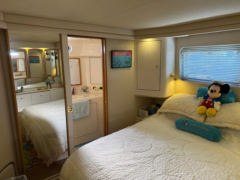 Slide: The Image of Cozy bedroom in 1998 Sea Ray 420 Aft Cabin with plush decor and nautical theme. - 30