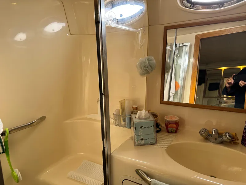 Slide: The Image of Bathroom interior of 1998 Sea Ray 420 Aft Cabin yacht, featuring sink and shower area. - 31