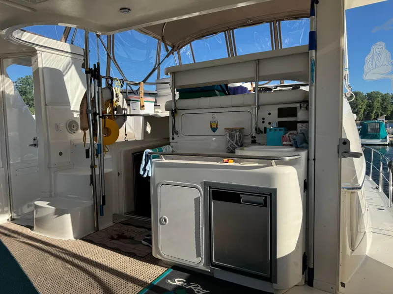 Slide: The Image of 1998 Sea Ray 420 Aft Cabin interior with kitchenette and fishing gear. - 5