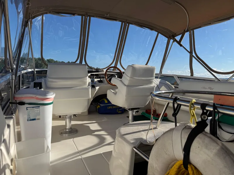 Slide: The Image of 1998 Sea Ray 420 Aft Cabin interior with helm, seating, and life jackets. - 6