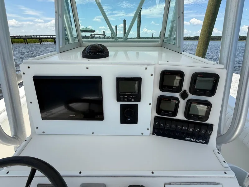 Slide: The Image of 2006 Regulator 26 Forward Seating boat dashboard with navigation and control instruments. - 12