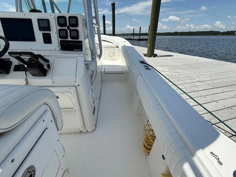 Slide: The Image of 2006 Regulator 26 Forward Seating boat docked, featuring a clean white interior and control panel. - 14