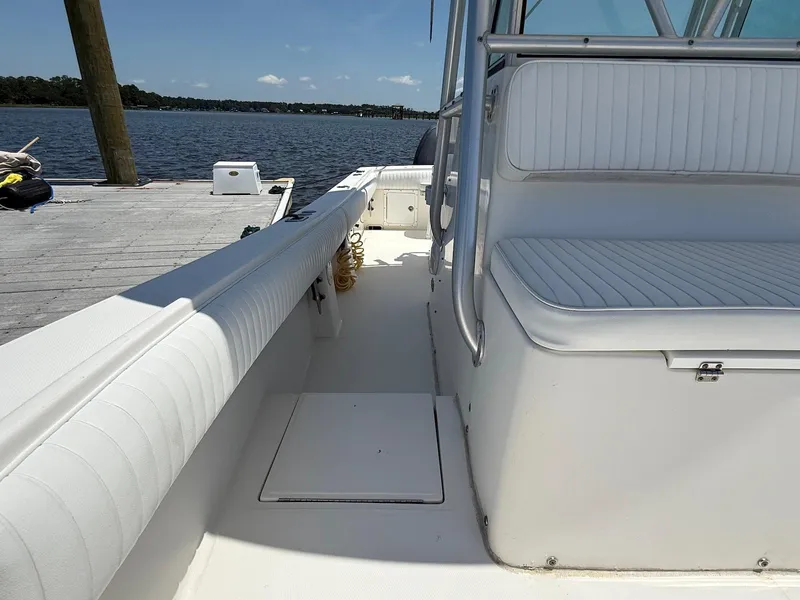 Slide: The Image of 2006 Regulator 26 Forward Seating boat docked by a serene lake. - 17