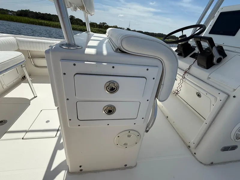 Slide: The Image of 2006 Regulator 26 Forward Seating boat interior with storage compartments and steering wheel. - 21