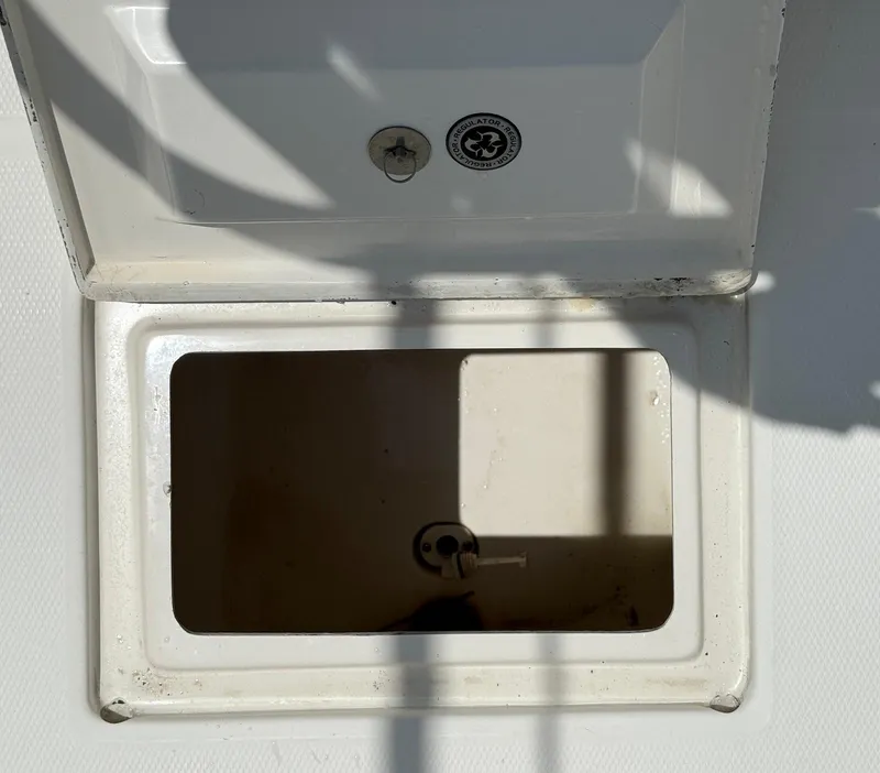 Slide: The Image of Open storage compartment on a 2006 Regulator 26 Forward Seating boat. - 24