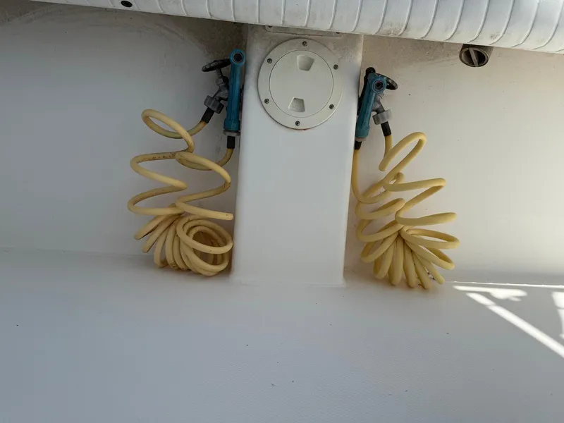 Slide: The Image of Coiled hoses on a 2006 Regulator 26 Forward Seating boat deck. - 25