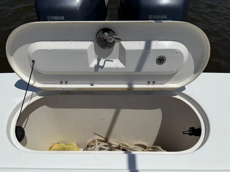 Slide: The Image of Open storage compartment on 2006 Regulator 26 Forward Seating boat with Yamaha engines. - 28