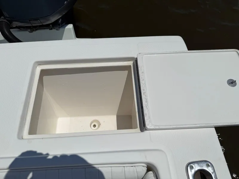 Slide: The Image of Open storage compartment on a 2006 Regulator 26 Forward Seating boat. - 29