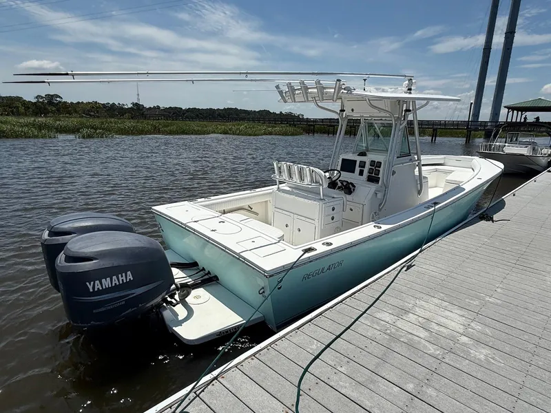 Slide: The Image of 2006 Regulator 26 Forward Seating boat docked with twin Yamaha engines. - 3
