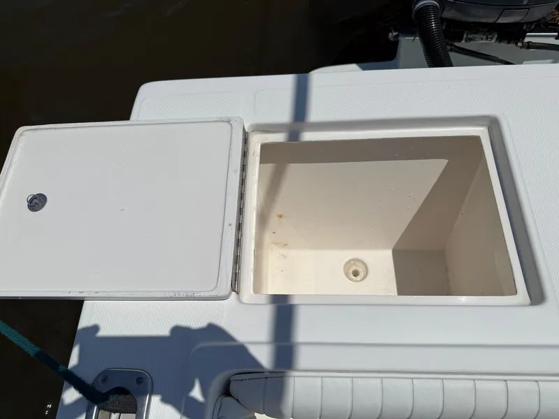 Slide: The Image of Open storage compartment on a 2006 Regulator 26 Forward Seating boat. - 30