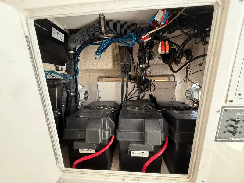 Slide: The Image of Battery compartment of a 2006 Regulator 26 Forward Seating boat, showing wiring and components. - 33