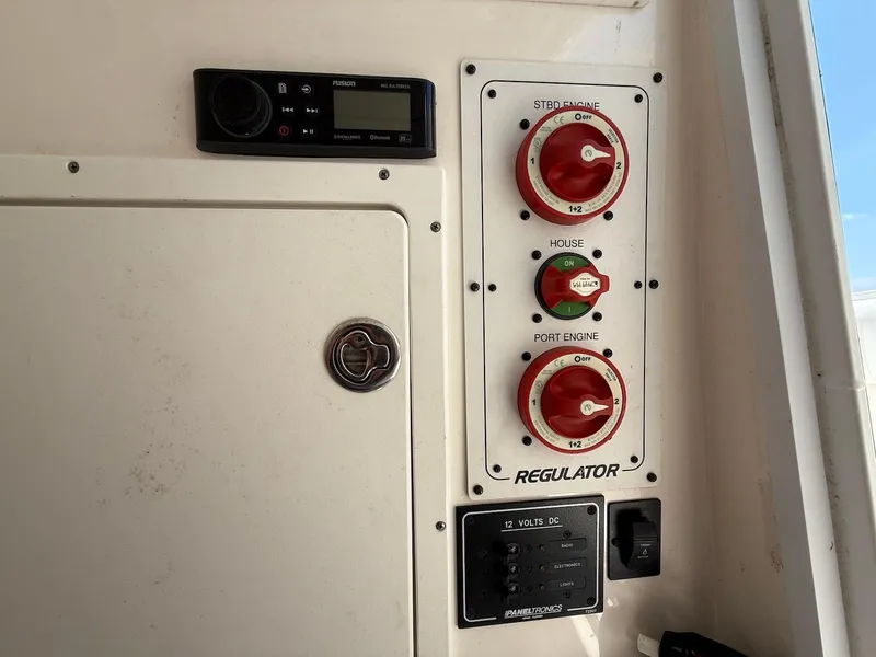 Slide: The Image of Control panel of a 2006 Regulator 26 Forward Seating boat with switches and dials. - 34