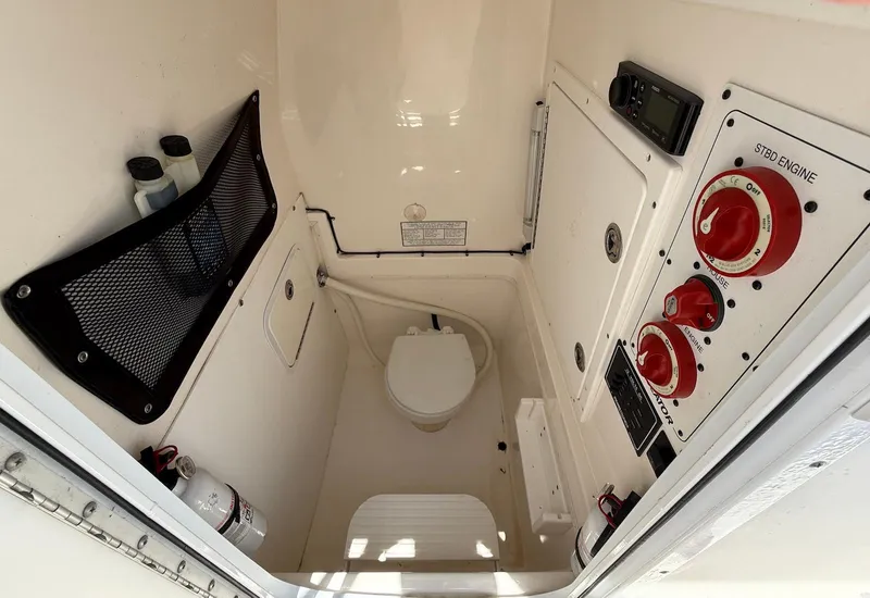 Slide: The Image of 2006 Regulator 26 Forward Seating boat interior with control panel and storage. - 35