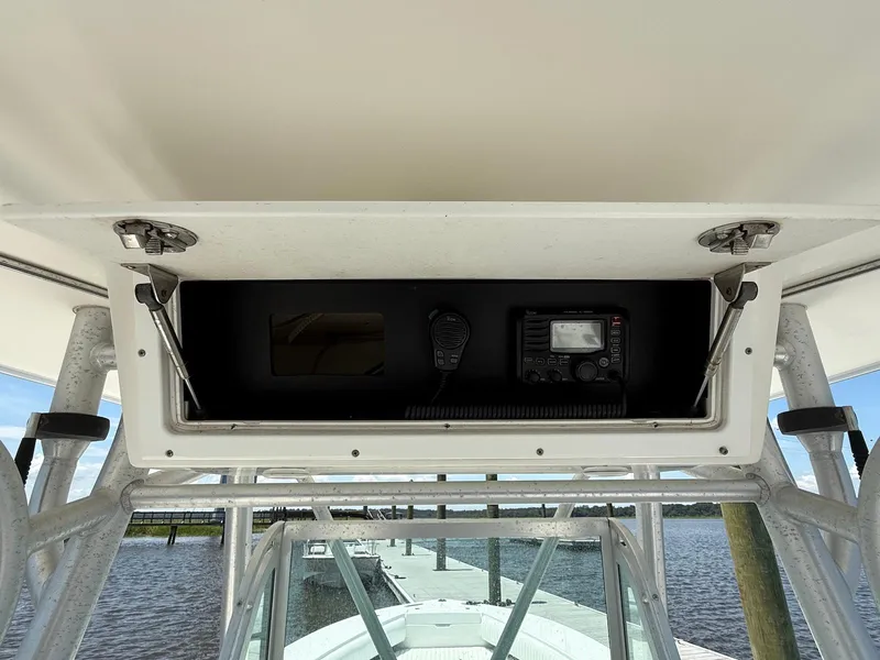 Slide: The Image of 2006 Regulator 26 Forward Seating boat console with radio equipment and open storage compartment. - 36