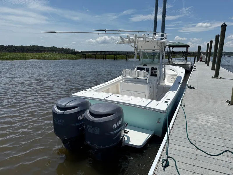 Slide: The Image of 2006 Regulator 26 Forward Seating boat docked with twin Yamaha engines. - 4