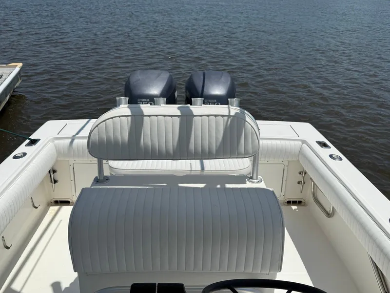 Slide: The Image of 2006 Regulator 26 Forward Seating boat with twin Yamaha engines on calm water. - 6