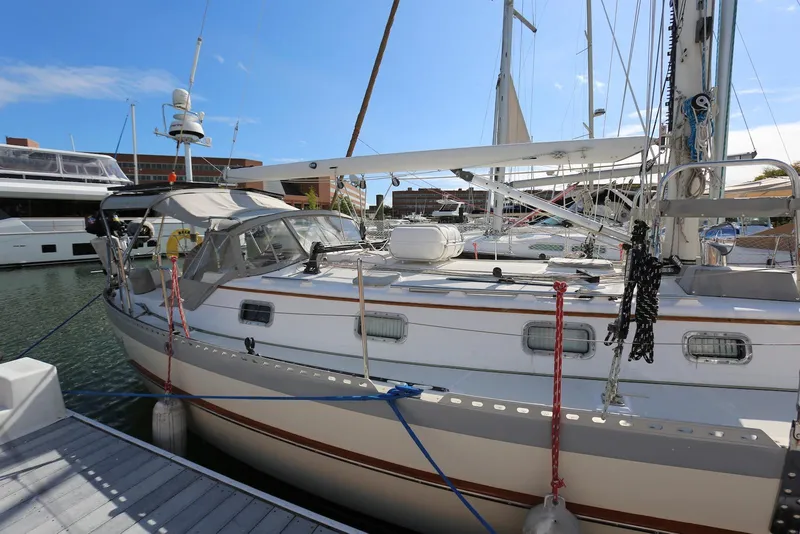 Slide: The Image of 2004 Pacific Seacraft Crealock 40 sailboat docked in marina under clear blue sky. - 10