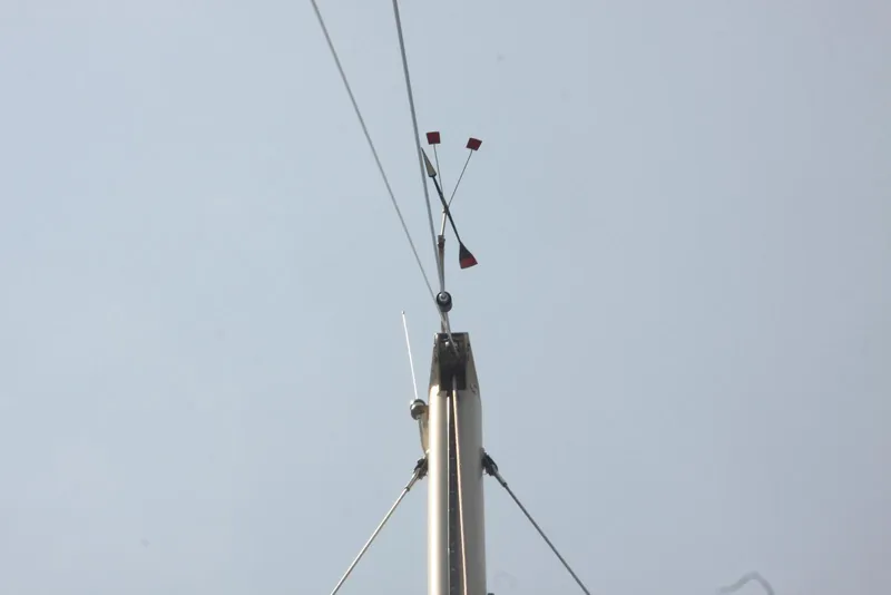Slide: The Image of Mast of 2004 Pacific Seacraft Crealock 40 sailboat with wind vane against clear sky. - 11