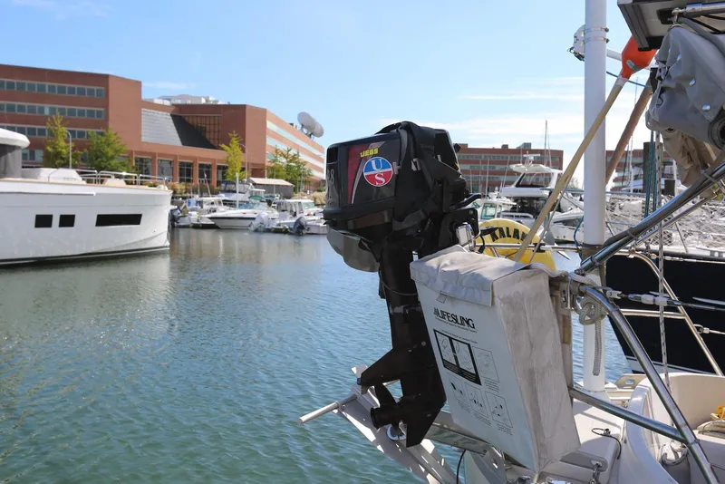 Slide: The Image of 2004 Pacific Seacraft Crealock 40 sailboat docked in marina with outboard motor and lifesling. - 17