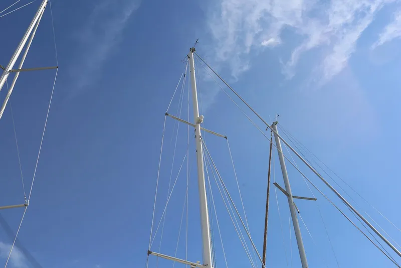 Slide: The Image of Masts of a 2004 Pacific Seacraft Crealock 40 sailboat against a clear blue sky. - 20