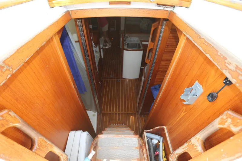 Slide: The Image of Interior view of 2004 Pacific Seacraft Crealock 40 sailboat, featuring wooden finishes and compact layout. - 30