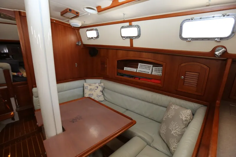 Slide: The Image of Interior of 2004 Pacific Seacraft Crealock 40 sailboat with cozy seating and wooden accents. - 31