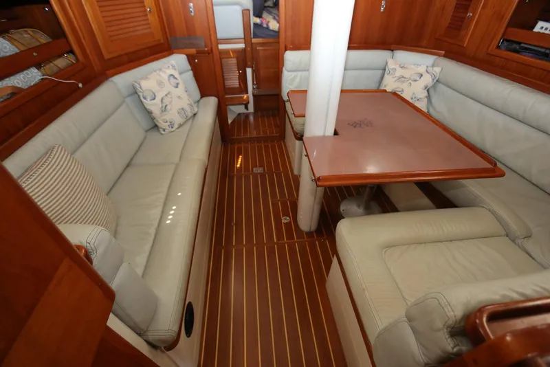 Slide: The Image of Interior of 2004 Pacific Seacraft Crealock 40 sailboat with cozy seating and wooden finishes. - 33